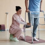 Physiotherapist helping a patient walk