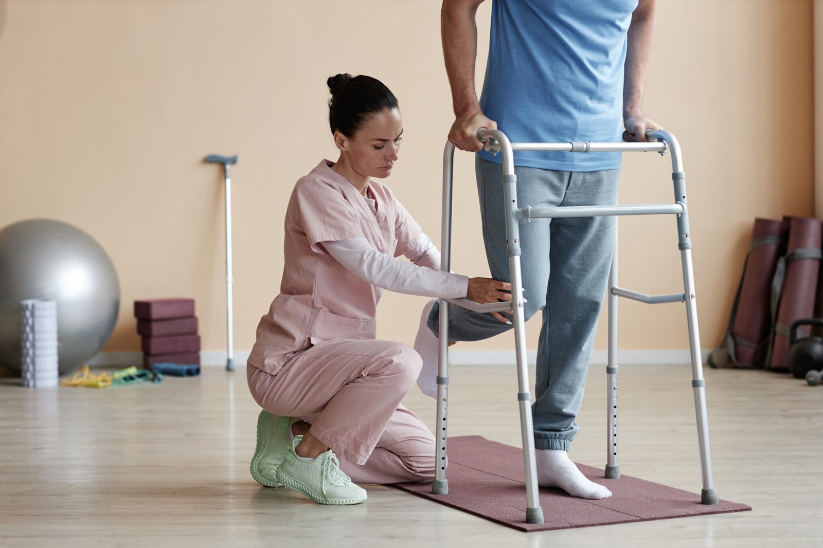 Physiotherapist helping a patient walk