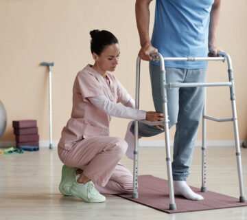 Physiotherapist helping a patient walk