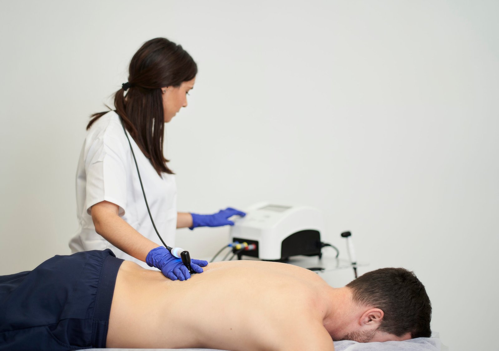 A female physiotherapist giving diathermy treatment on the patient's back
